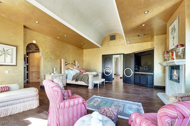 bedroom with dark hardwood / wood-style flooring and high vaulted ceiling