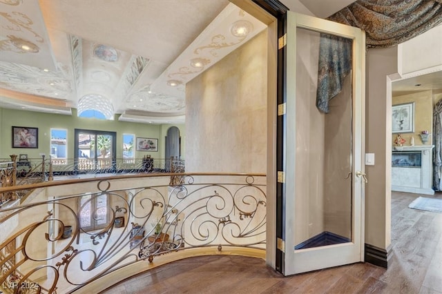 hallway with hardwood / wood-style floors