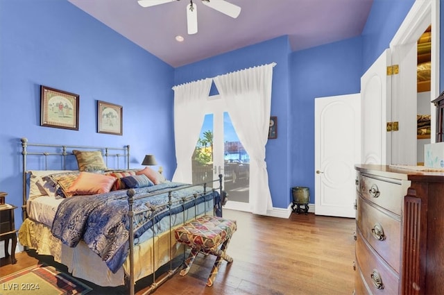 bedroom with hardwood / wood-style flooring, ceiling fan, and access to exterior