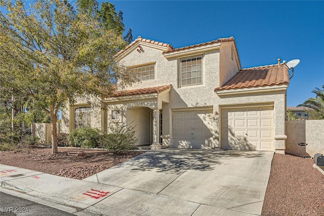 2133 Desert Pines St, Las Vegas, NV 89134 - mediterranean / spanish home featuring a tiled roof, concrete driveway, stucco siding, and a garage
