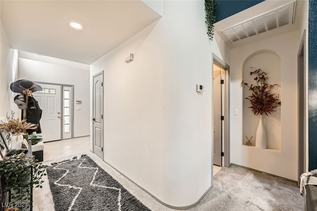 view of carpeted entrance foyer