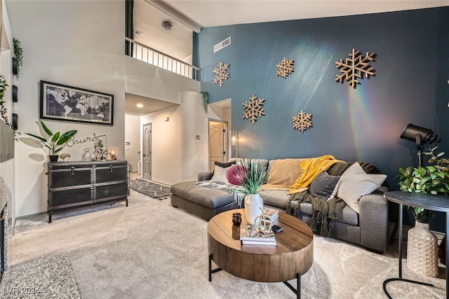 living room with high vaulted ceiling and carpet floors