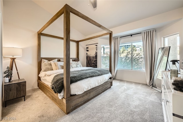 carpeted bedroom featuring ceiling fan and vaulted ceiling