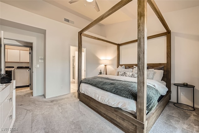 carpeted bedroom featuring washing machine and dryer and ceiling fan