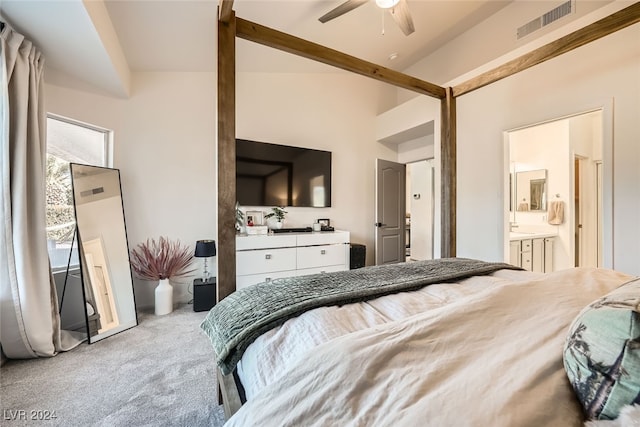 carpeted bedroom with ensuite bathroom, high vaulted ceiling, and ceiling fan