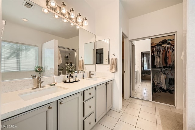 bathroom with vanity, tile patterned flooring, and an enclosed shower