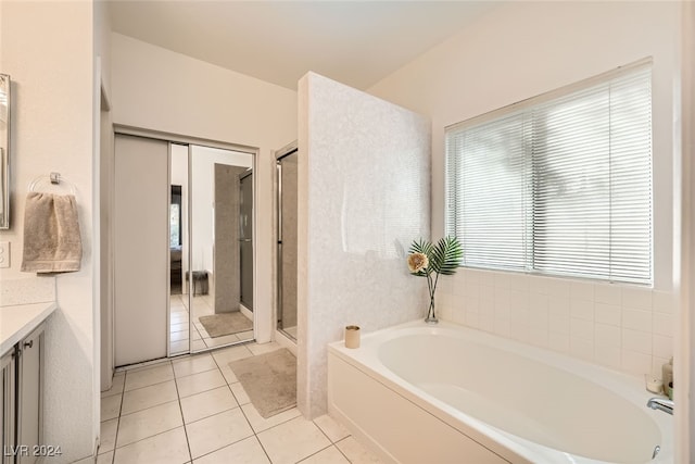 bathroom with vanity, tile patterned floors, and shower with separate bathtub