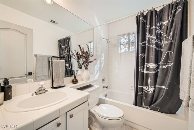 full bathroom with shower / bath combo, vanity, and toilet