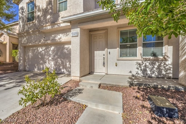 doorway to property with a garage