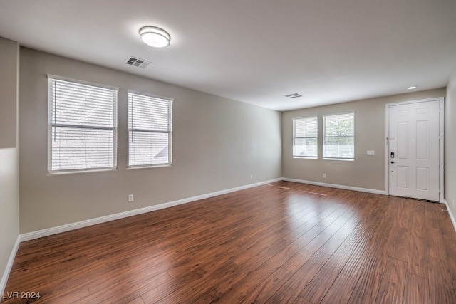 unfurnished room with dark hardwood / wood-style flooring