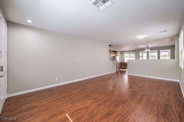 unfurnished living room featuring dark hardwood / wood-style floors and ceiling fan