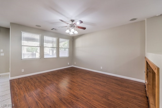 unfurnished room with dark hardwood / wood-style flooring and ceiling fan