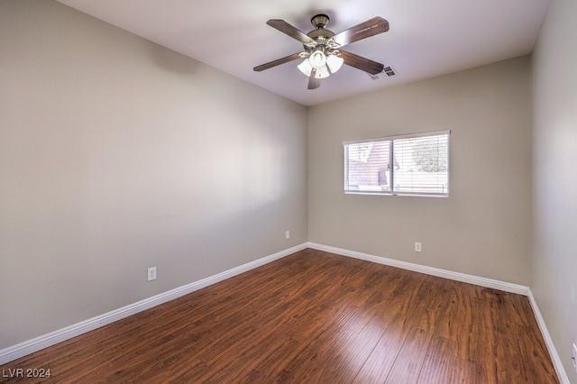 unfurnished room with dark hardwood / wood-style flooring and ceiling fan