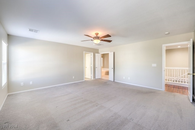 carpeted empty room featuring ceiling fan