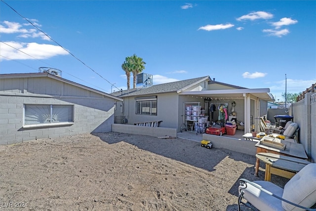 rear view of property with central AC and a patio area