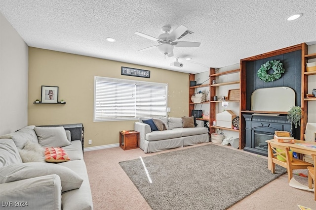 living room featuring a textured ceiling, light colored carpet, and ceiling fan