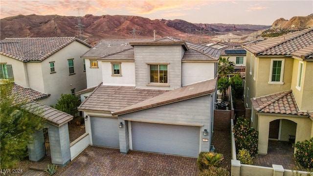 view of front facade with a mountain view and a garage