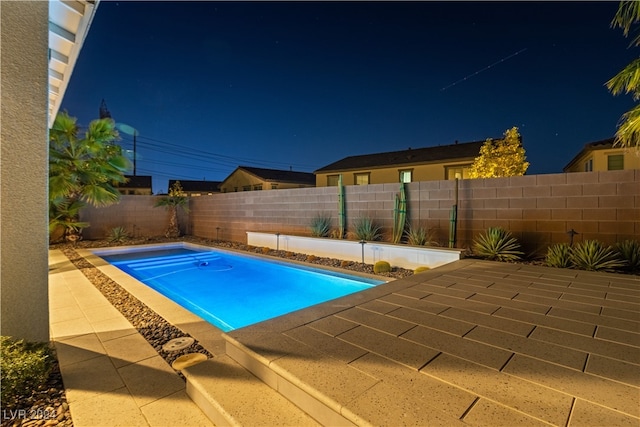 view of pool at night