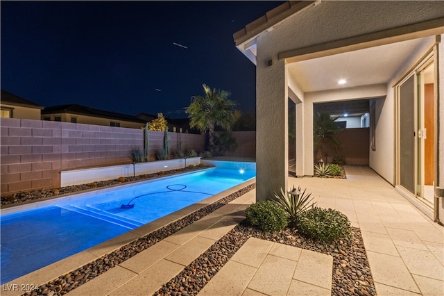 view of pool at night