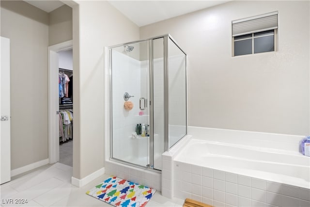 bathroom with tile patterned floors and separate shower and tub