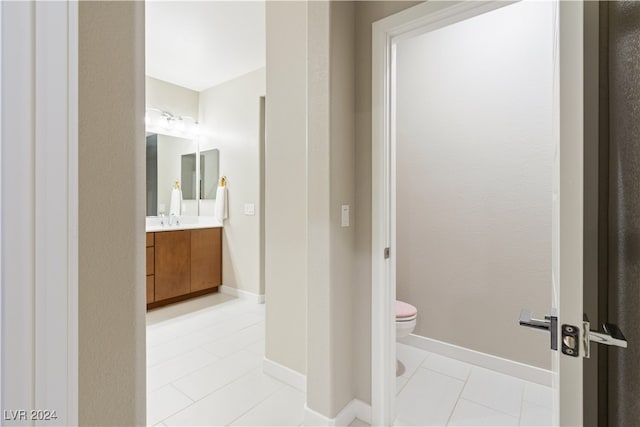 bathroom featuring tile patterned floors, vanity, and toilet