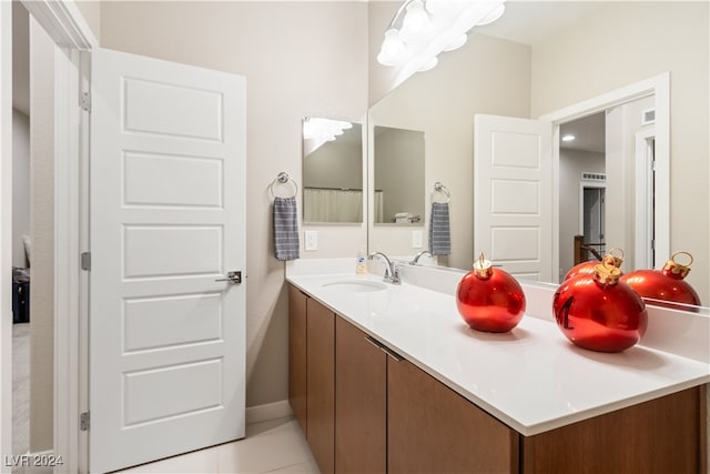 bathroom with tile patterned flooring and vanity