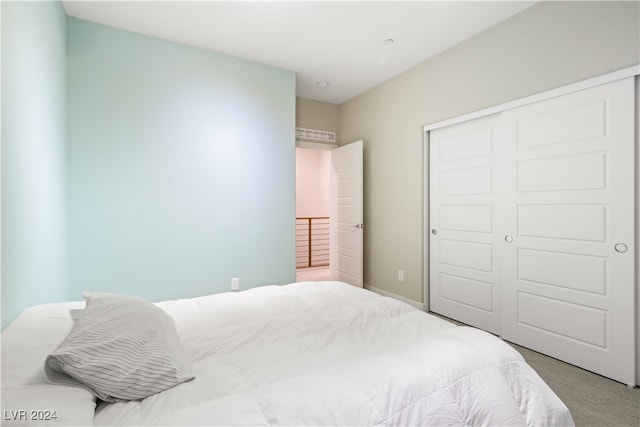 carpeted bedroom with a closet