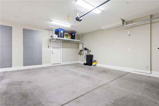 garage featuring a garage door opener and water heater