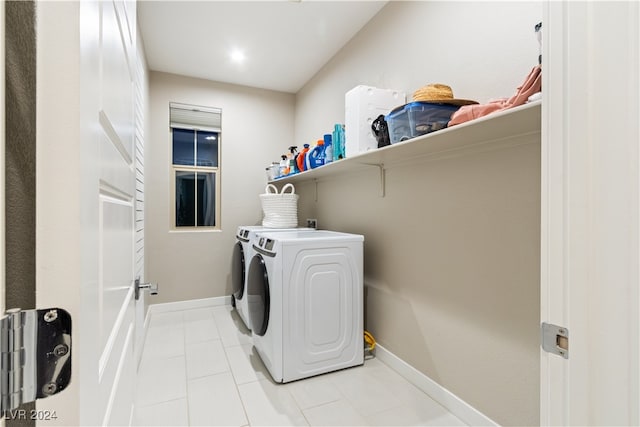 clothes washing area featuring light tile patterned floors and separate washer and dryer