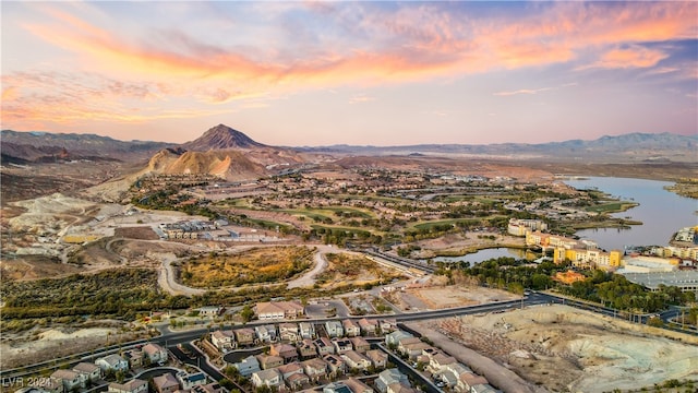 aerial view at dusk with a water and mountain view