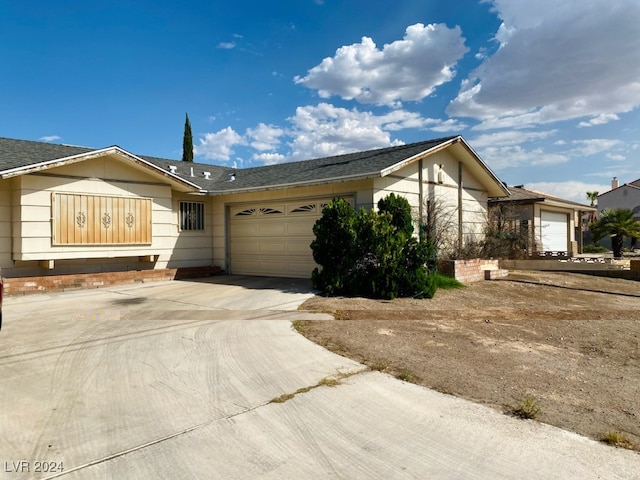 ranch-style home featuring a garage