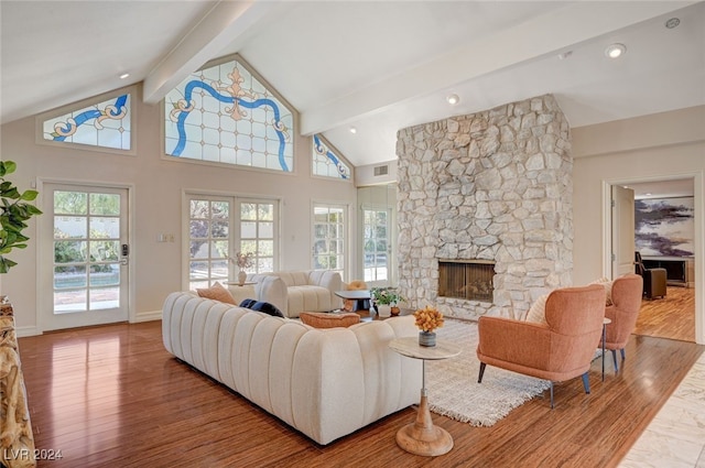 living room with beam ceiling, a fireplace, high vaulted ceiling, and wood-type flooring