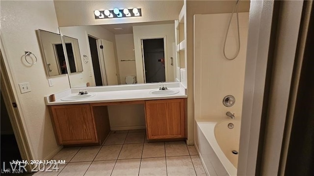 full bathroom featuring toilet, vanity, tile patterned floors, and shower / washtub combination