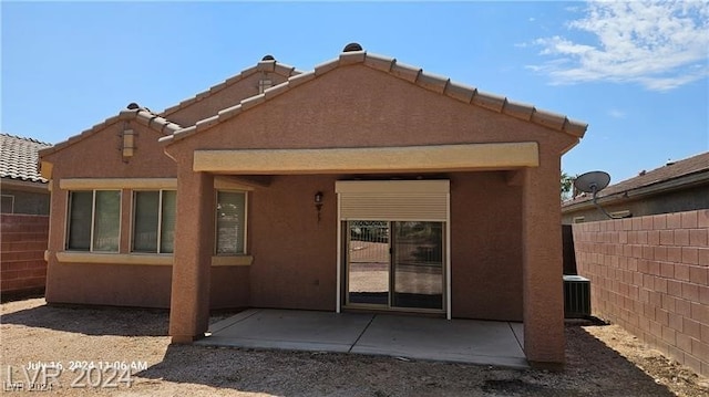 back of house with a patio