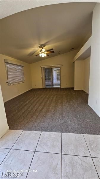 spare room featuring ceiling fan, carpet flooring, and lofted ceiling