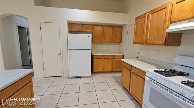 kitchen featuring white appliances and light tile patterned floors