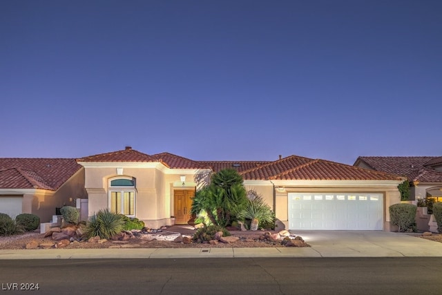 mediterranean / spanish-style home with a garage