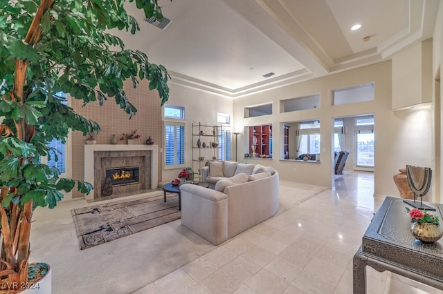 tiled living room with a high ceiling and a premium fireplace