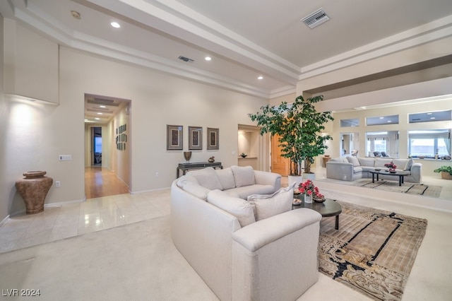 living room with light tile patterned flooring and crown molding