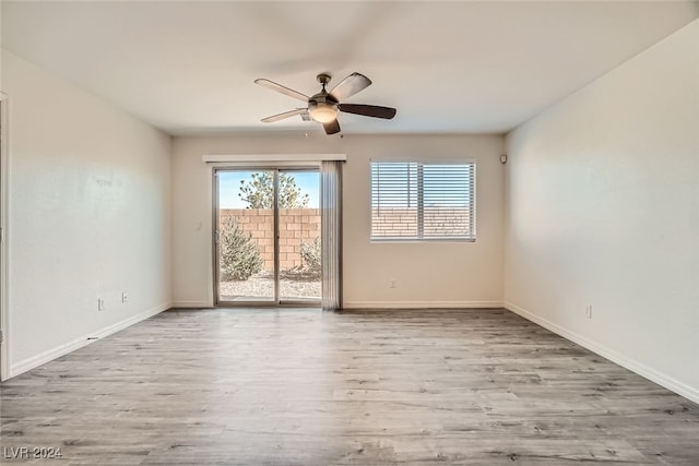 empty room featuring ceiling fan and light hardwood / wood-style floors