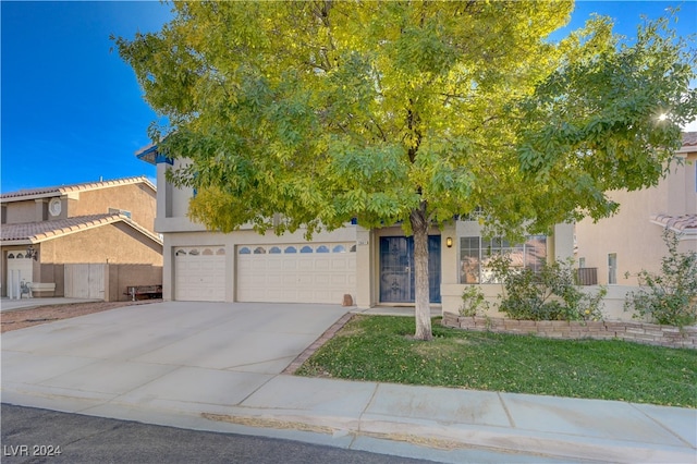 view of property hidden behind natural elements with a garage