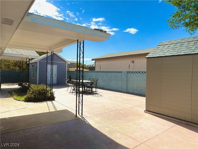 view of patio featuring a storage unit