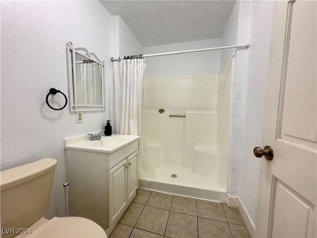 bathroom with tile patterned floors, a shower with curtain, vanity, a textured ceiling, and toilet