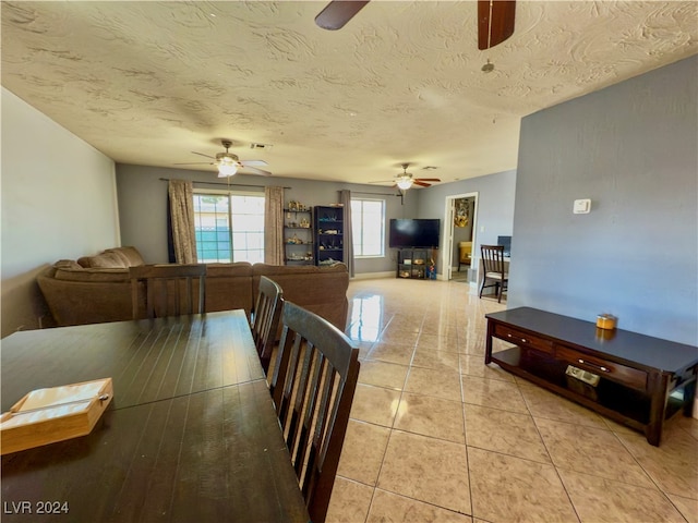 dining space with light tile patterned flooring and a textured ceiling