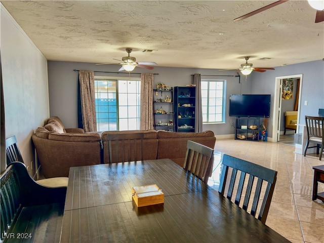 tiled dining room with a textured ceiling