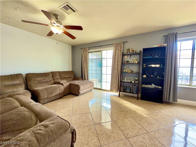 tiled living room featuring ceiling fan and a textured ceiling