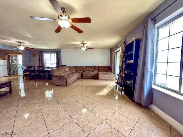 unfurnished living room with light tile patterned floors and a textured ceiling