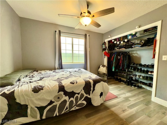 bedroom with ceiling fan, a closet, and light wood-type flooring