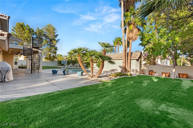 view of yard with a fenced in pool and a patio area