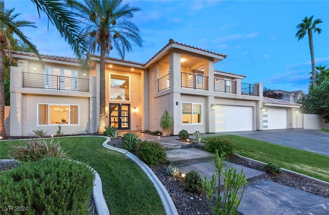 view of front of home featuring a garage and a balcony